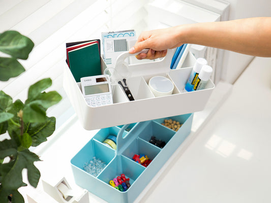 Portable blue and white storage caddy with office supplies