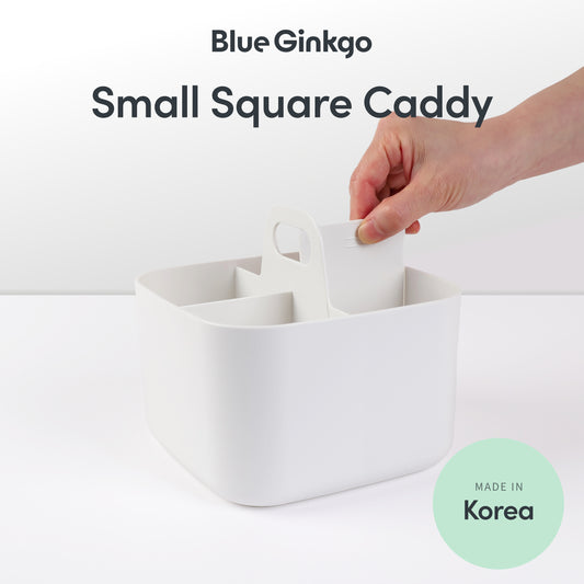 Square caddy with a hand removing the removable divider.