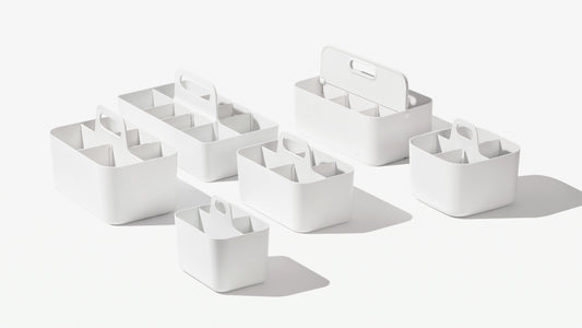 Selection of white storage caddies on a white background.