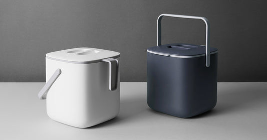 A black and white 5L Countertop Food Waste Bin on a white counter.