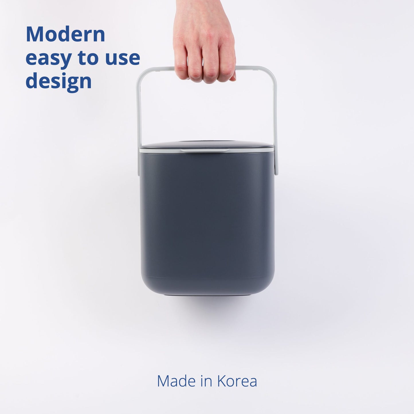 Hand carrying 2.6L Food Waste Bin by its handle on a white background.
