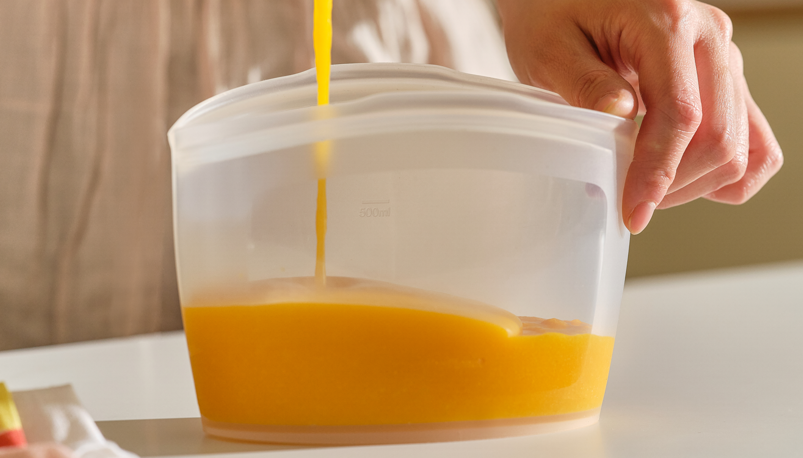 Food being poured into a premium Korean-made silicone bag.