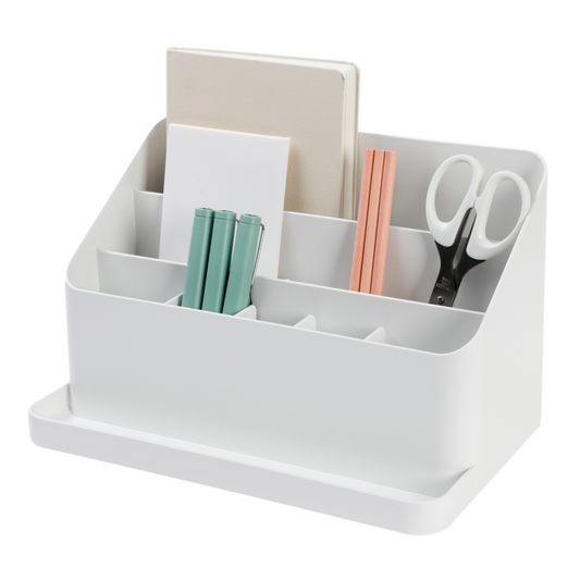 A white all-in-one desk organizer with adjustable dividers containing pens, paperclips, and other office supplies.