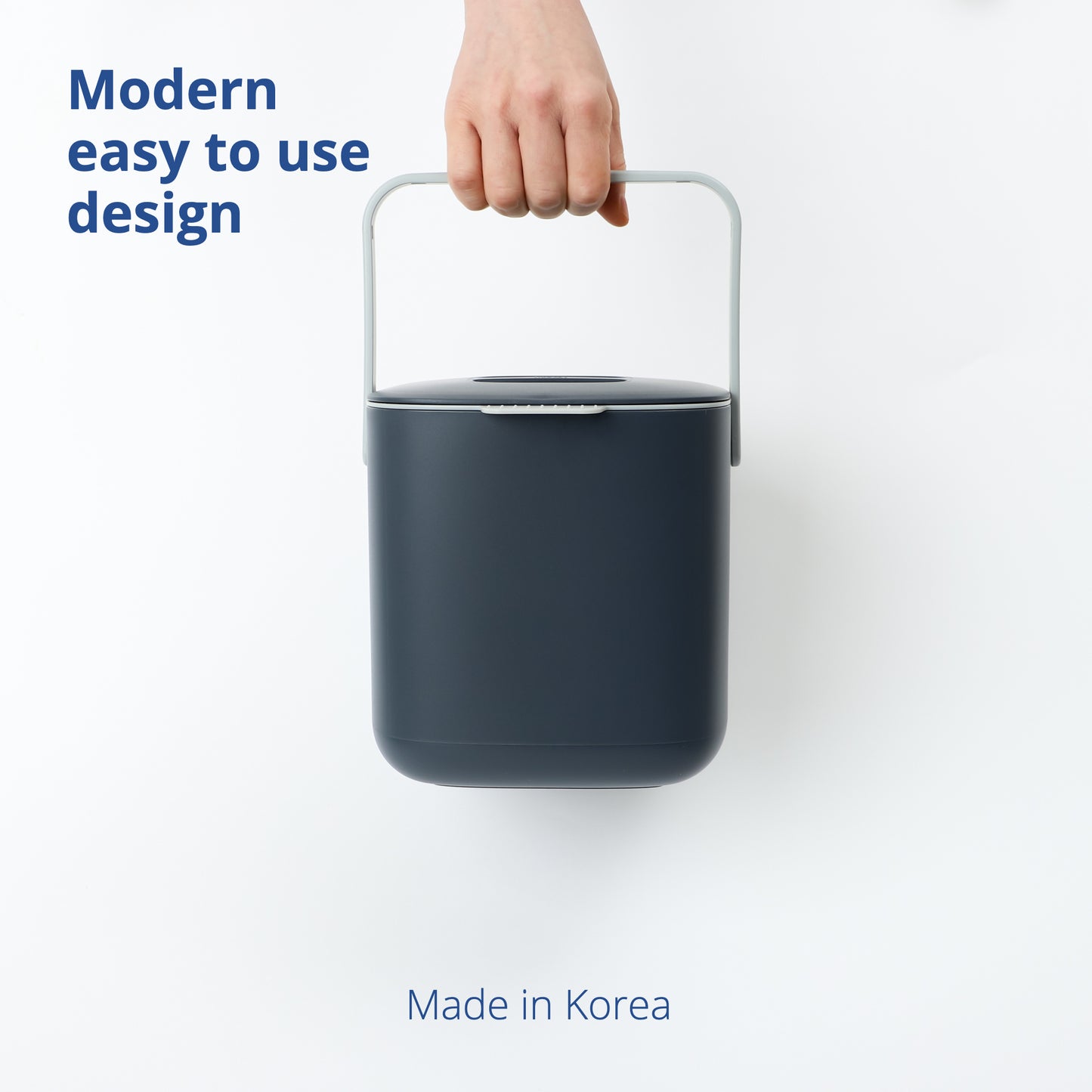 Hand carrying 2.6L Food Waste Bin by its handle on a white background.