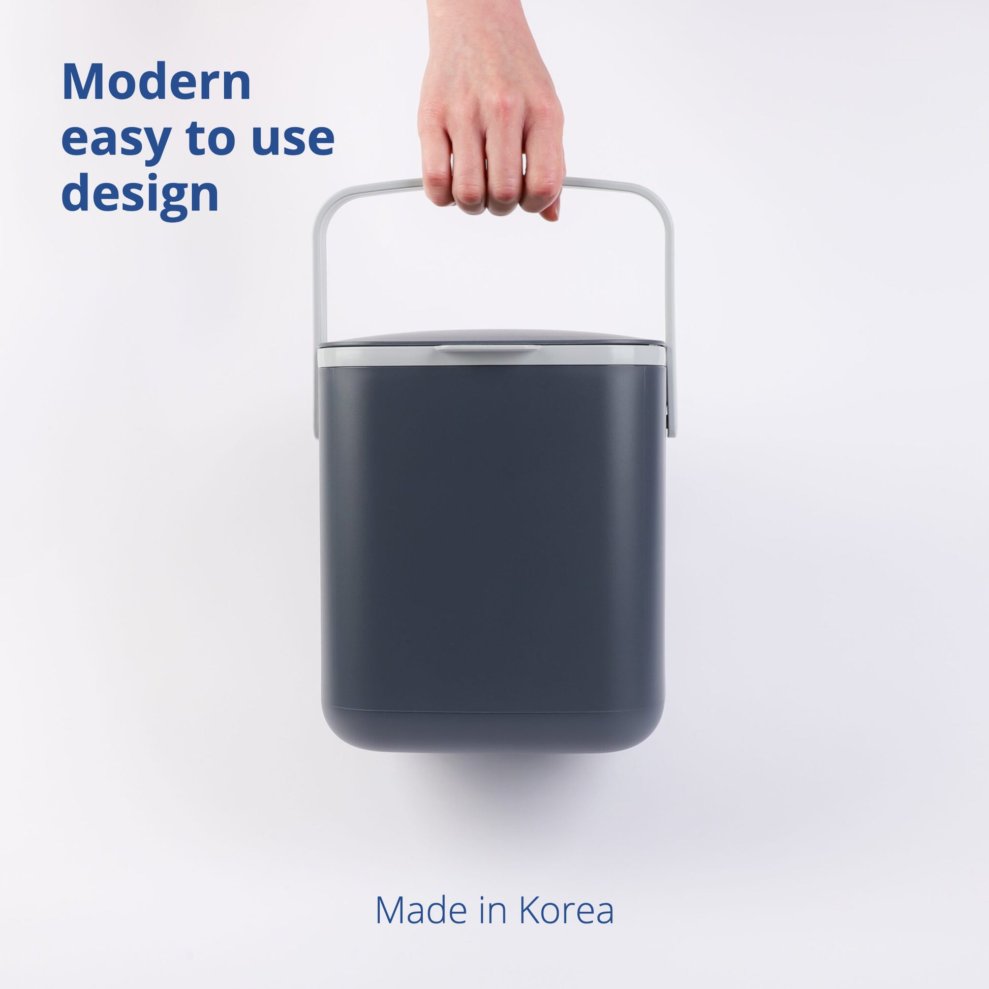 Hand carrying 5L Food Waste Bin by its handle on a white background.