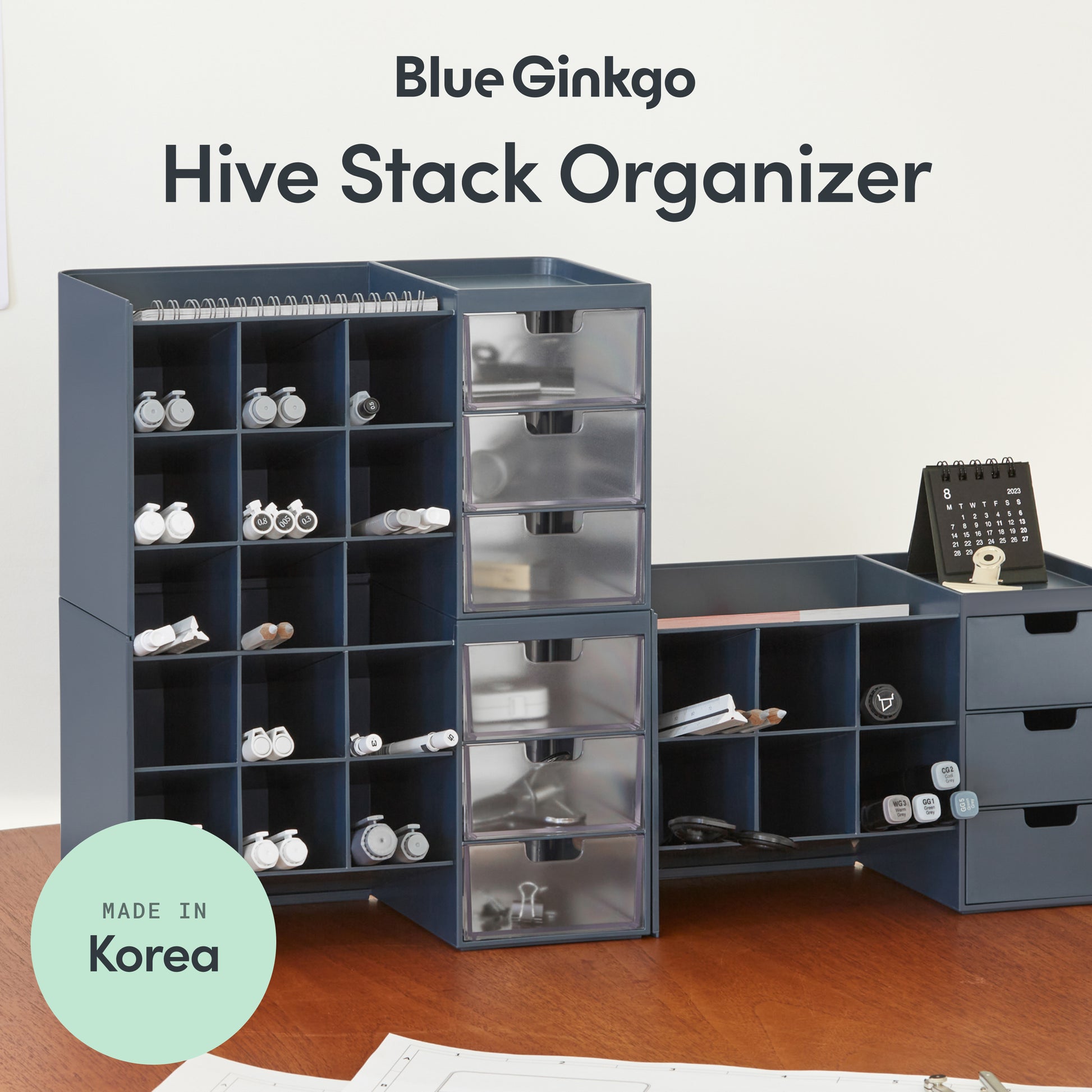 Blue Ginkgo Hive Stack Organizer with clear drawers on a wooden surface.