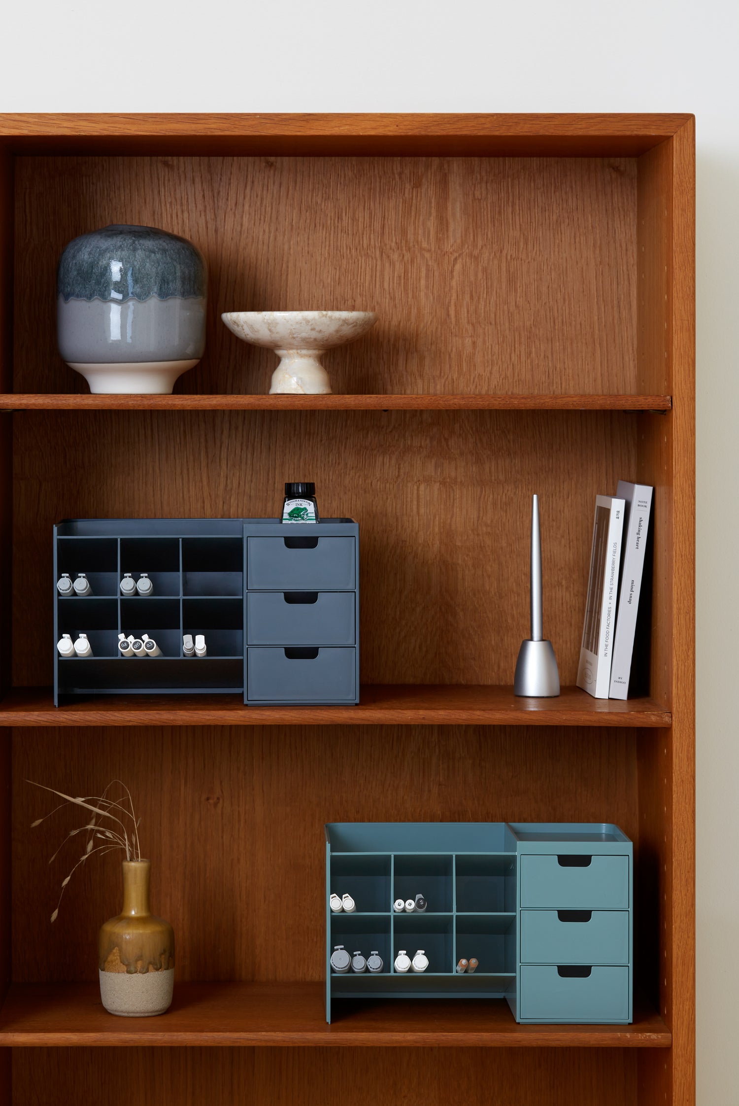 Two Hive Stack organizers placed on a wooden office shelf.