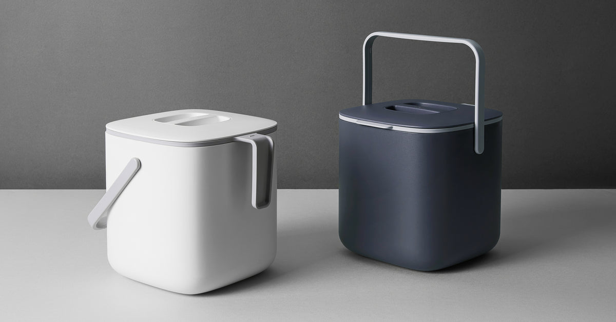 Two large White and Grey 5L Food Waste Bins from Blue Ginkgo on a grey backdrop 