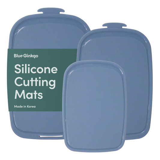 Blue Ginkgo blue silicone cutting board set on a white background.