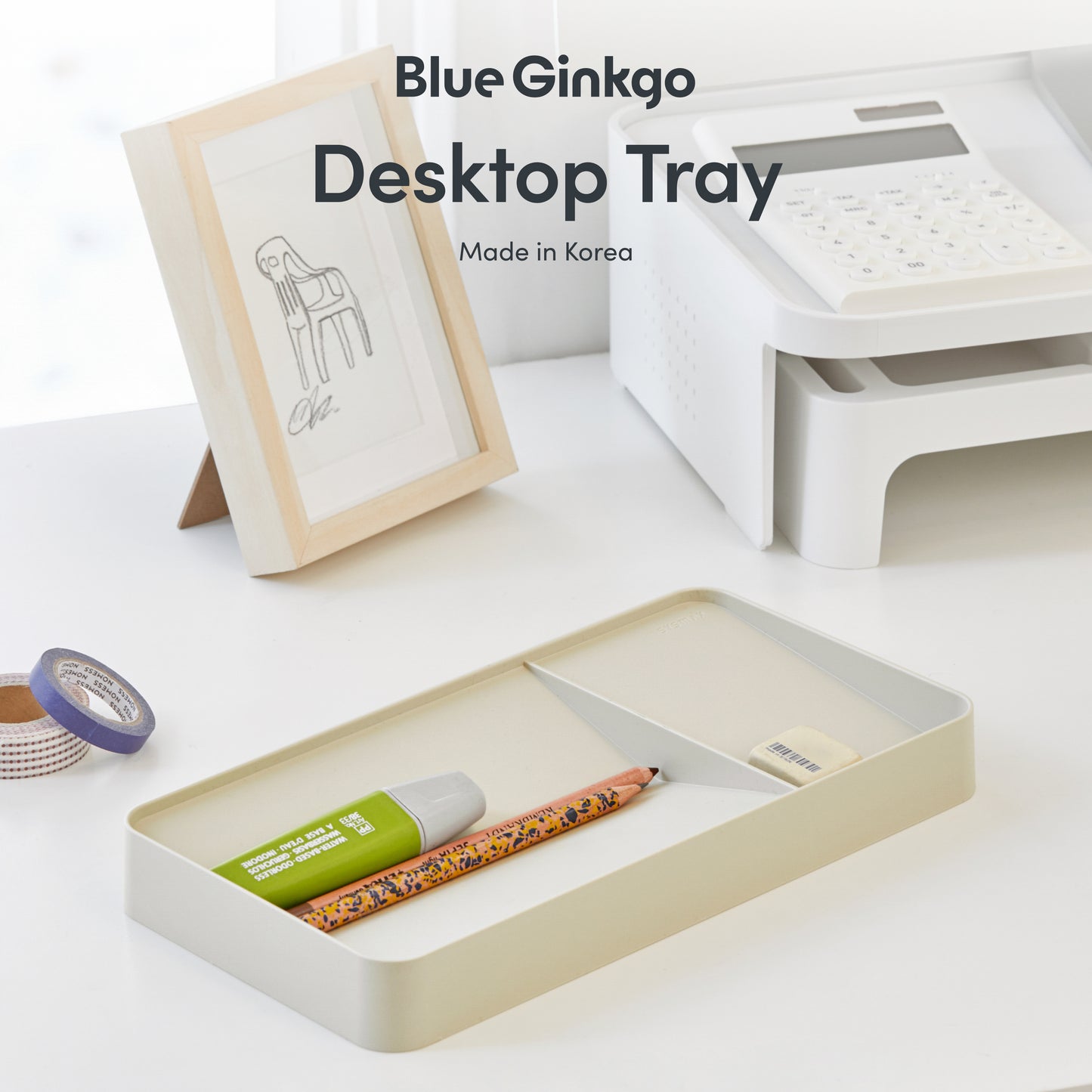 Blue Ginkgo desktop tray with stationery items on a white desk.